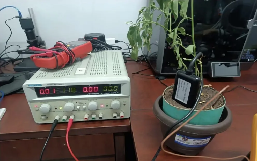 PICS physical prototype: a soil moisture sensor in a potted plant connected to a laboratory power supply